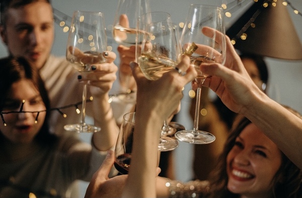 a group of happy people clinking together champagne flutes at a party